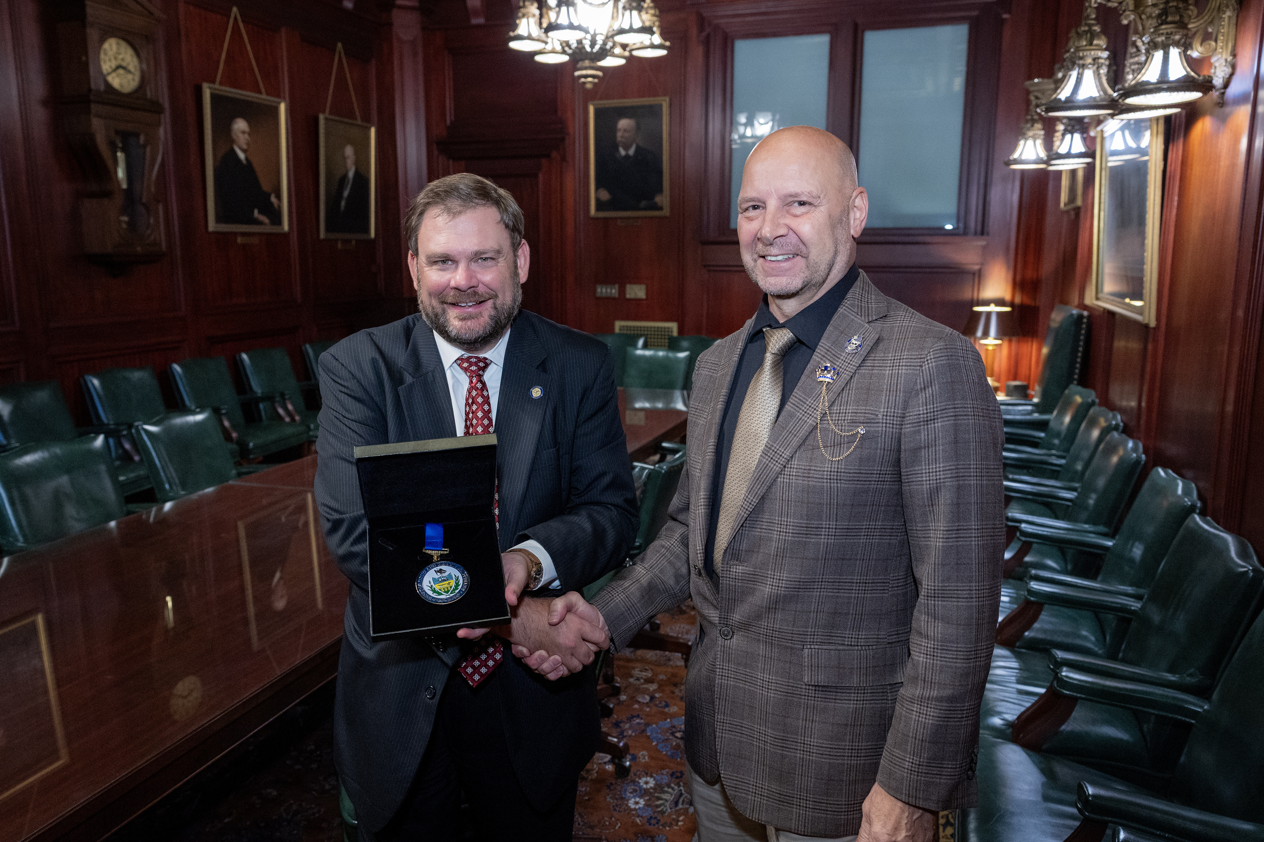 Sen. Pittman pictured receiving a medal of honor from Sen. Mastriano (also pictured)